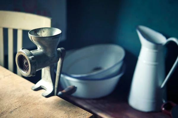 Vintage meat grinder on wooden table and bowl with jug — Stock Photo, Image