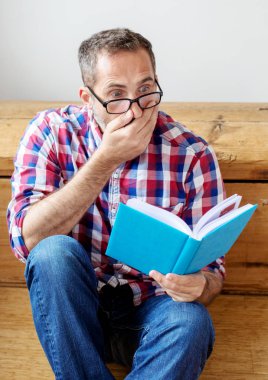 handsome bearded man reading a book  clipart