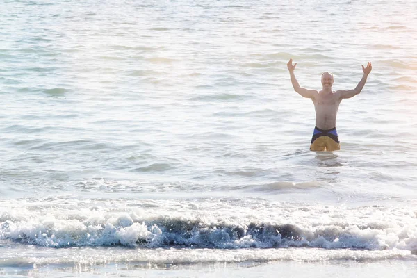 Homme debout dans l'eau à la plage — Photo