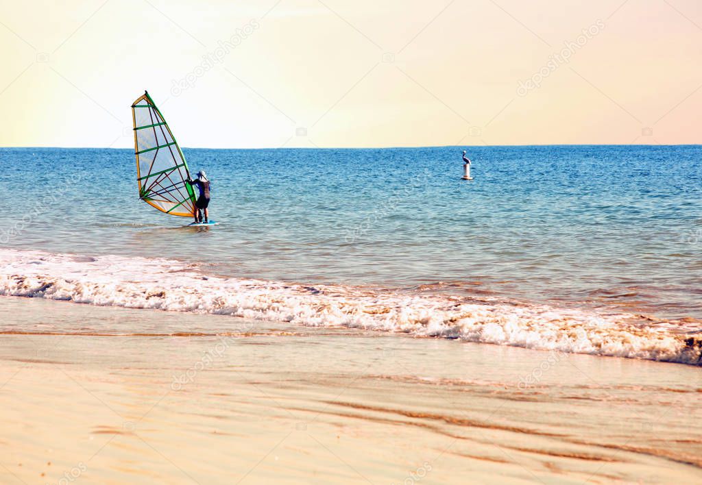 surfer on his surfboard at beach in the water