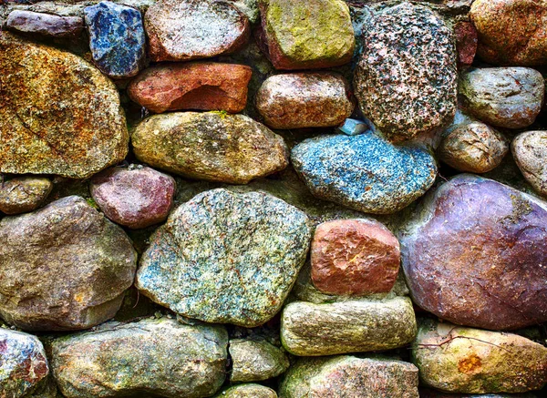 Closeup of colorful stonewall out of big stones — Stock Photo, Image