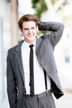 yakışıklı adam kaldırımda yürüyen ve gülümseyen elbiseli