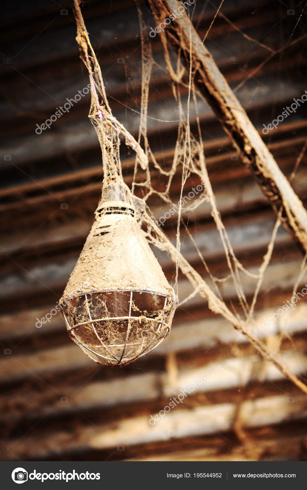 Rusty lamp hanging from ceiling with spiderwebs — Stock Photo ©  wernerimages #195544952