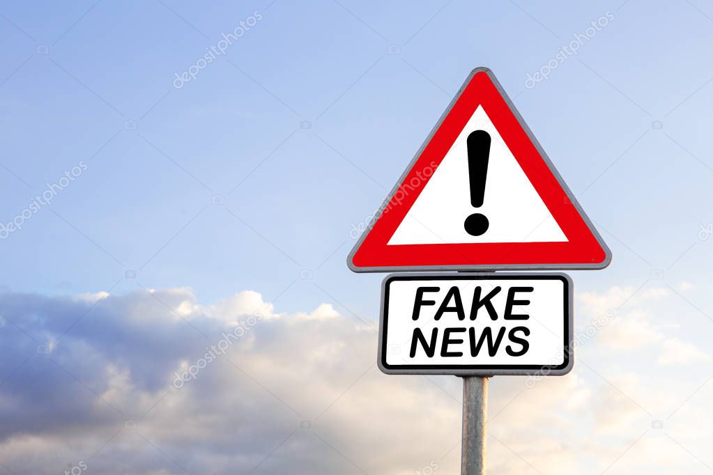 blue sky and road sign with the words Fake News