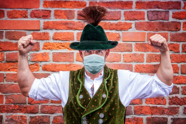 Bavarian Man Flexing His Muscles Wearing Protective Mask — Stock Photo, Image