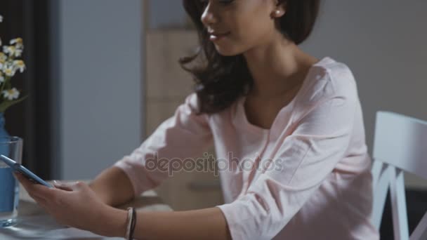 Mujer joven usando el teléfono móvil en casa. — Vídeos de Stock