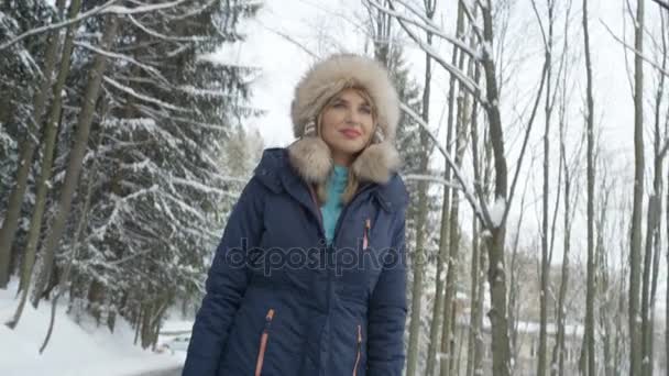 Portrait of smiling woman enjoying winter in a mountain forest. — Stock Video