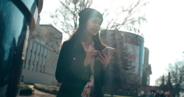 Portrait of young African American woman using phone, outdoors. — Stock Photo, Image