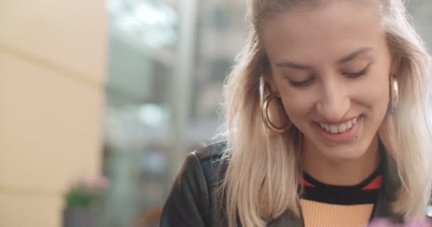 Giovane donna caucasica digitando al telefono in un caffè della città . — Video Stock