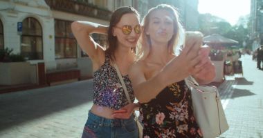 İki genç güzel kız selfie bir şehir sokak alarak. 