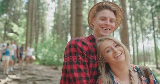 Portrait of beautiful caucasian couple spending time in a forest during sunny day. — Stock Video