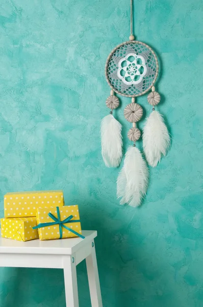 Gray white dream catcher on aquamarine