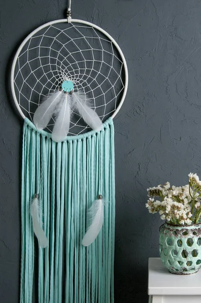 Mint dream catcher on bedroom interior