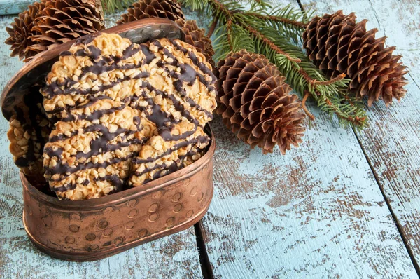 Cookies in copper box and christmas tree branches