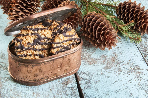 Cookies in copper box and christmas tree branches