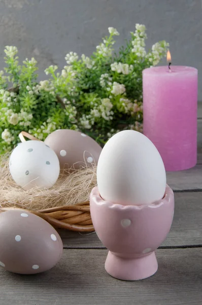 Eggs and rose aroma candle on old wooden background — Stock Photo, Image