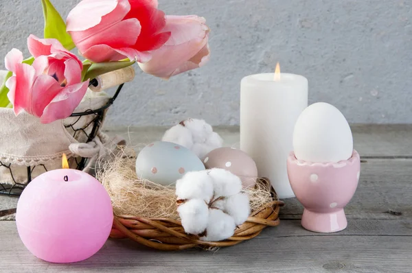 Eggs and aroma candles on old wooden background — Stock Photo, Image