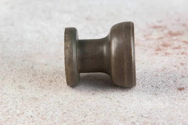 Antique bronze drawer pull knob on concrete background. Copy space for text.