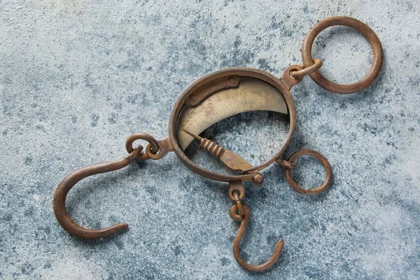 Antique brass iron rusty hand scales with hooks  on concrete background. Copy space for text.