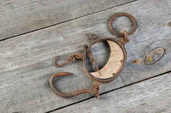 Antique brass iron rusty hand scales with hooks  on wooden background. Copy space for text.