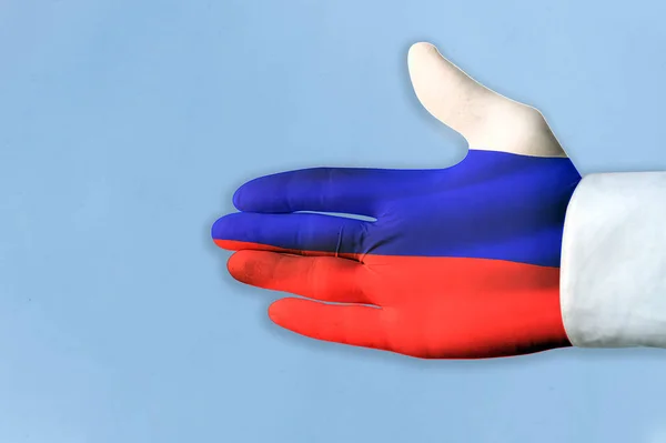 Russian flag on hand of help. Concept on the topic of helping from Russia