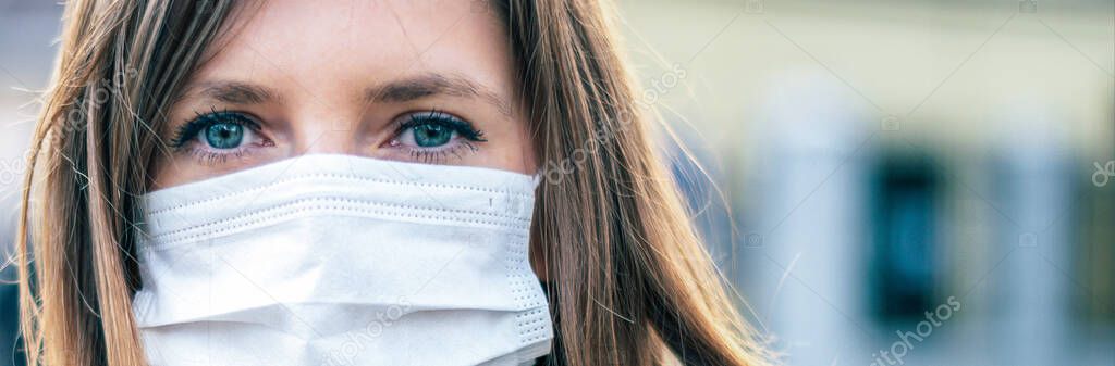 Virus mask. COVID-19. Woman walking in public space wearing face protection in prevention for coronavirus. 