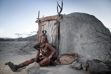 Himba woman poses in her village clipart