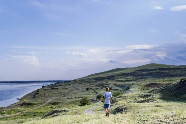 the young man goes on a mountain track