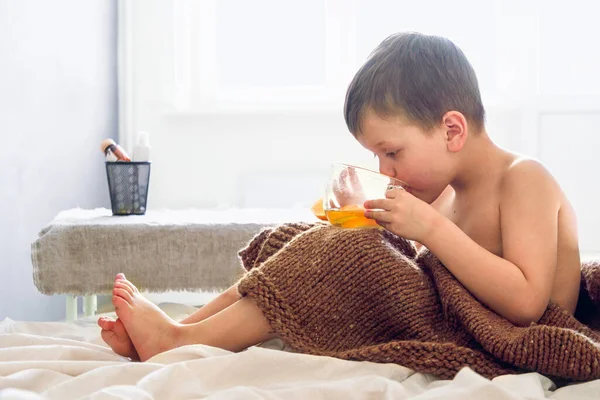 Jongen Bedekt Met Een Wollen Deken Zit Zijn Bed Drinkt Stockfoto