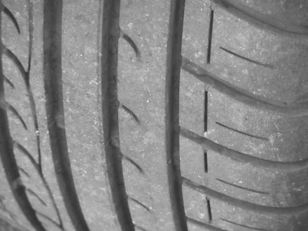 Old and worn black tire tread background — Stock Photo, Image