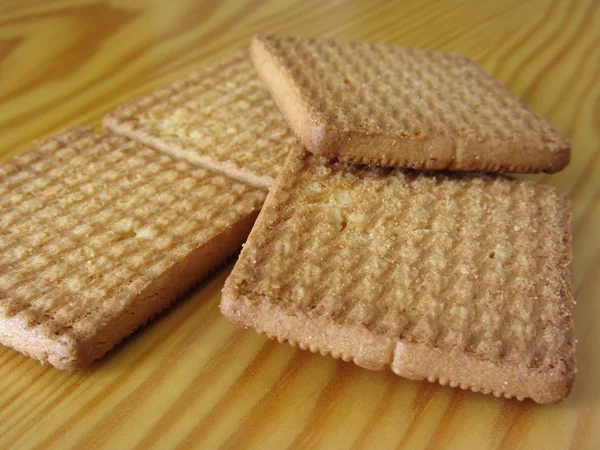 Sluiten van koekjes op houten tafel. Vier koekjes als ontbijt. — Stockfoto