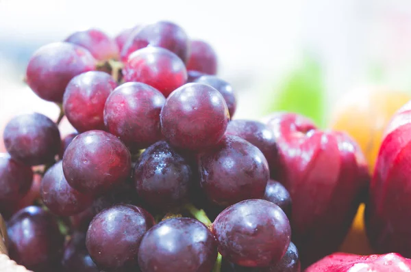 bunch of grape and  rose apple