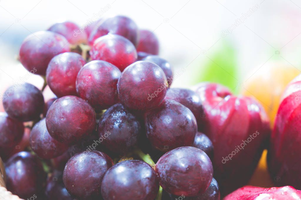 bunch of grape and  rose apple