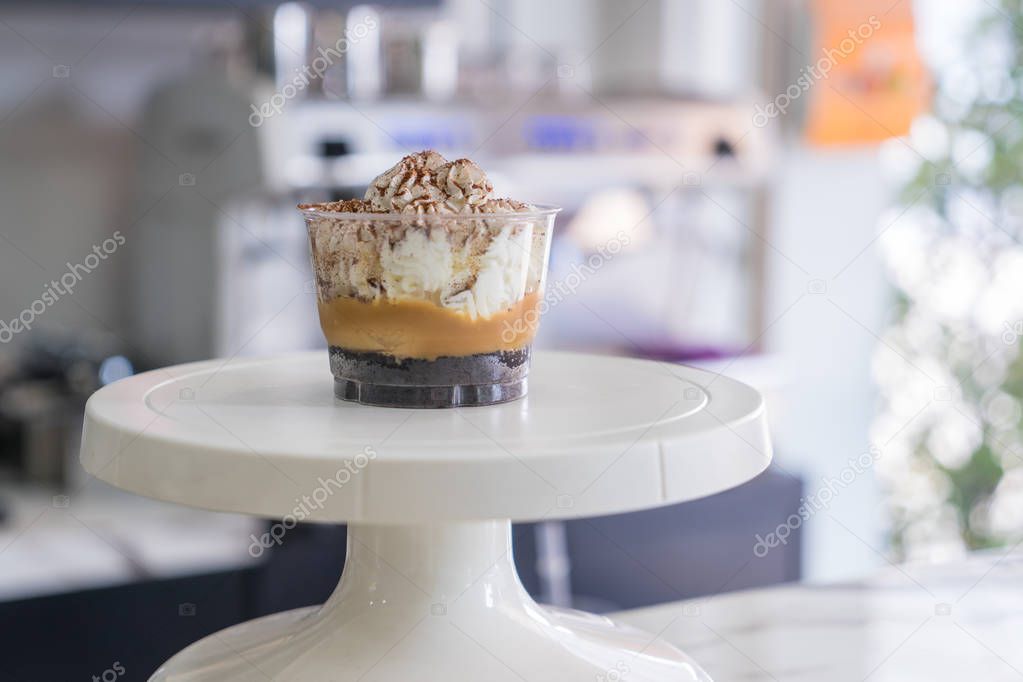 soft focus of Banoffee cups  on Cake Decorating Turntable in coffee shop