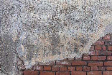 Old Weathered Damaged Concrete Wall Texture With a Few Bricks Visible