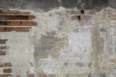 Old Weathered Concrete Decay Wall Texture With a Few Red Bricks Visible
