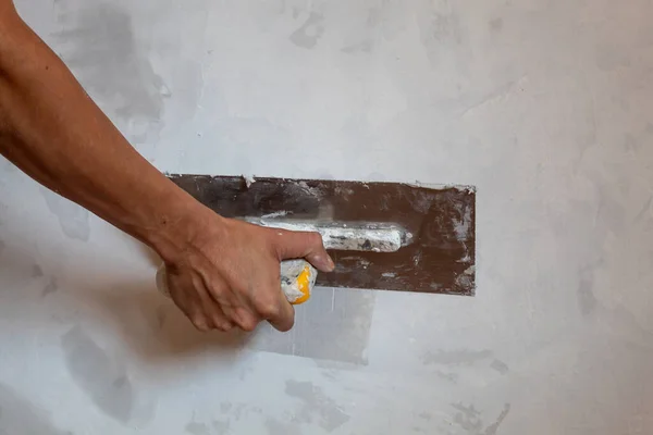 Woman Hand Holding a Trowel For Plaster