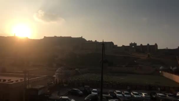 Jaipur, India, November 05, 2019, Amer Fort, tourists walk in the parking lot against the sunrise — Stock Video