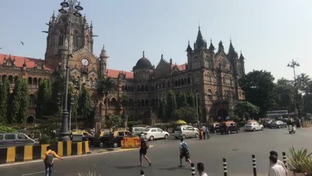 Mumbai, India - November 10, 2019: Chhatrapati Shivaji Terminus tourists walk past the building of the railway station part 5 — Stock Video