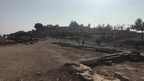 Umm Qais, Jordanien - 17. Oktober 2019: Touristen studieren die Überreste antiker Mauern Teil 2 — Stockvideo