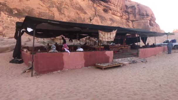 Wadi Rum, Jordan - October 17, 2019: Tourists on holiday after gruelling desert safari part 6 — ストック動画