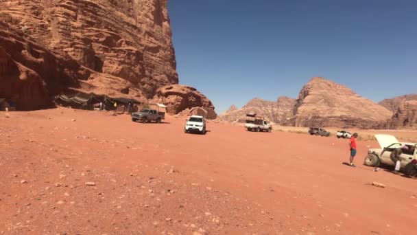 Wadi Rum, Jordan - October 17, 2019: Tourists on holiday after gruelling desert safari part 9 — Wideo stockowe