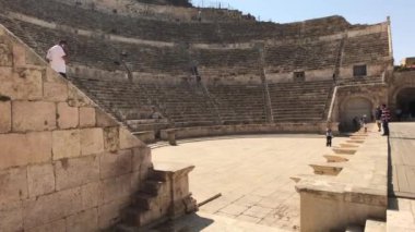 Amman, Jordan - October 20, 2019: Roman Amphitheater tourists walk through the ruins part 12