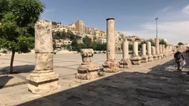 Amman, Jordan - October 20, 2019: Roman Amphitheater tourists walk through the ruins part 4