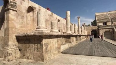 Amman, Jordan - October 20, 2019: Roman Amphitheater tourists walk through the ruins part 7