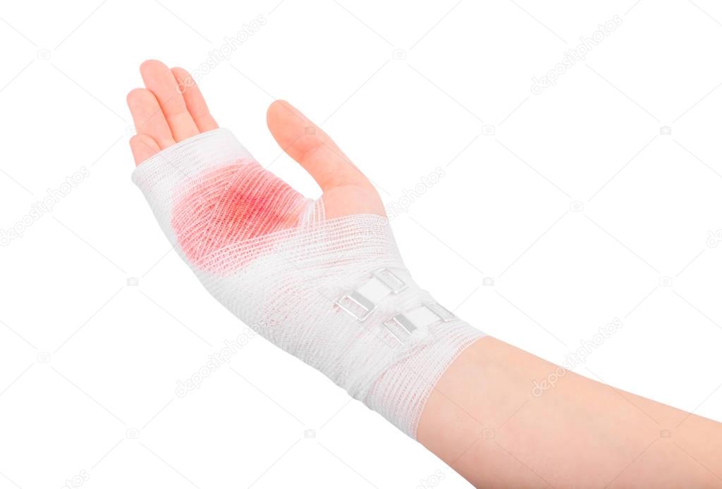 Injured hand of the girl tied up by white bandage