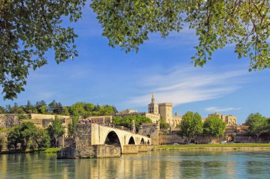 The famous medieval bridge in the town of Avignon, in southern France ( from Island of Barthelasse ) clipart