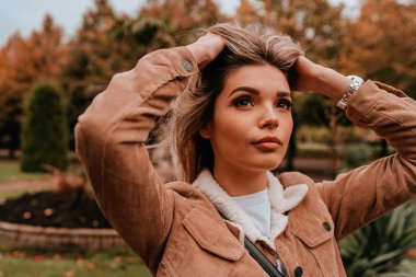 Sarı saçlı, sokak stili, çekici bir genç kadın portresi.