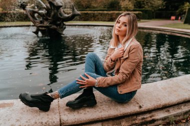 Sarı saçlı, sokak stili, çekici bir genç kadın portresi.