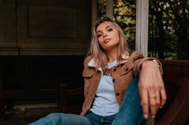 Sarı saçlı, sokak stili, çekici bir genç kadın portresi.